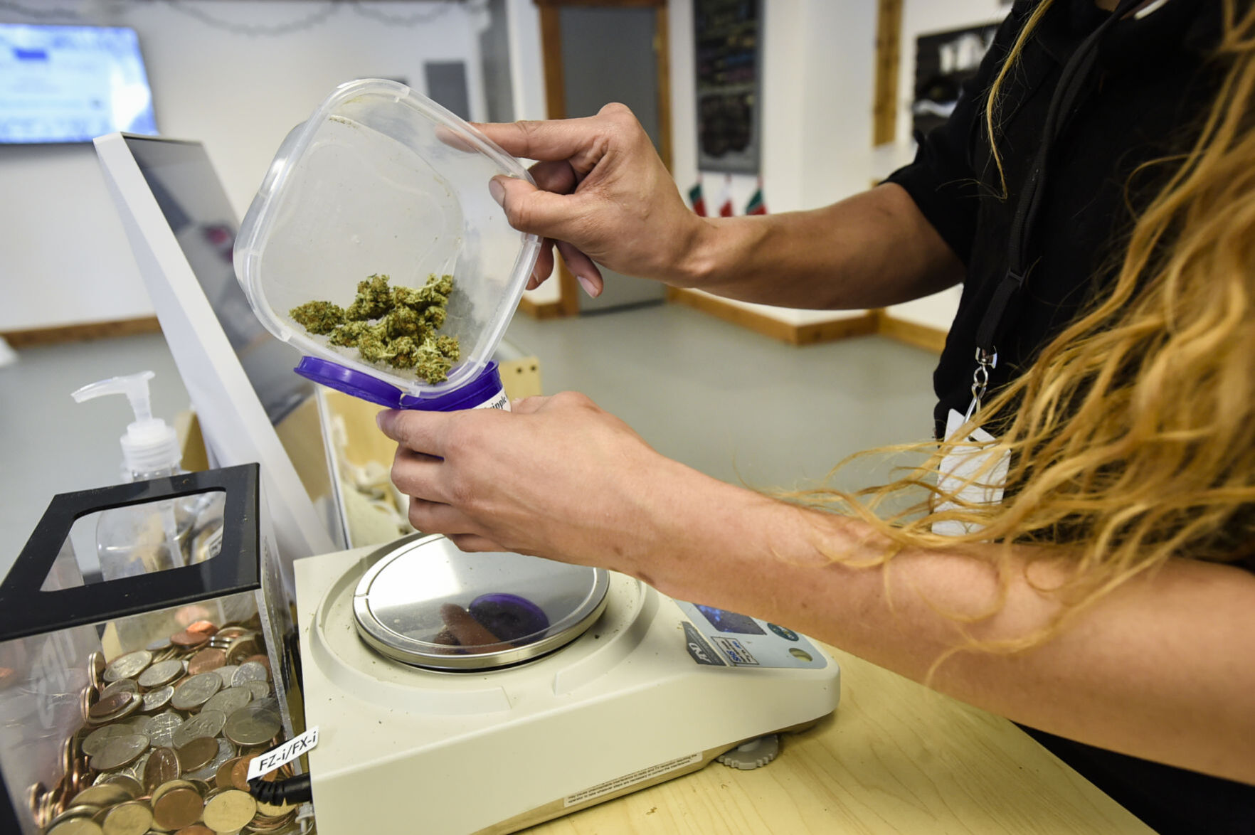 Rochelle Porter packages marijuana buds for a customer